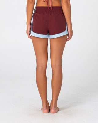 Woman wearing Elastic Panel Crank Boardshort in Cranberry / Retro Blue