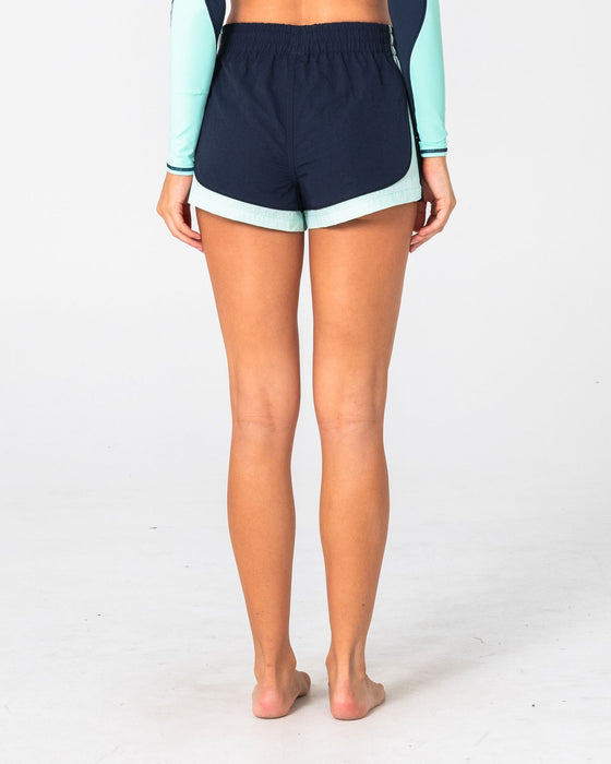 woman-wearing-elastic-panel-crank-boardshort-in-navy-blue-aqua