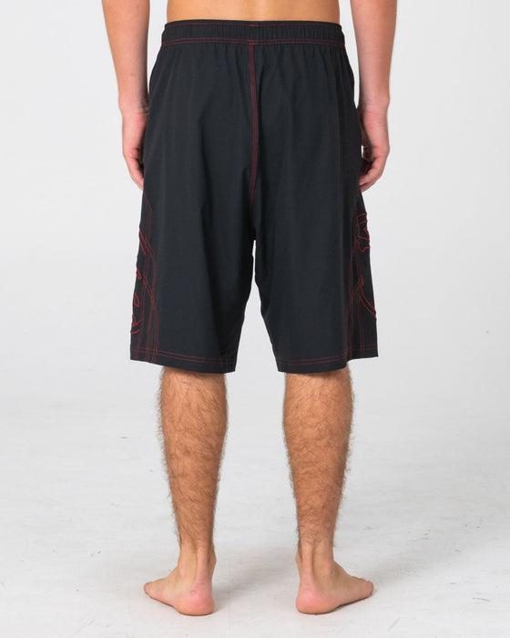 man-wearing-tombstones-hybrid-waist-boardshort-in-black-red