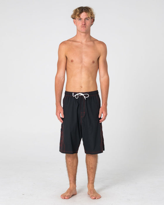 man-wearing-tombstones-hybrid-waist-boardshort-in-black-red