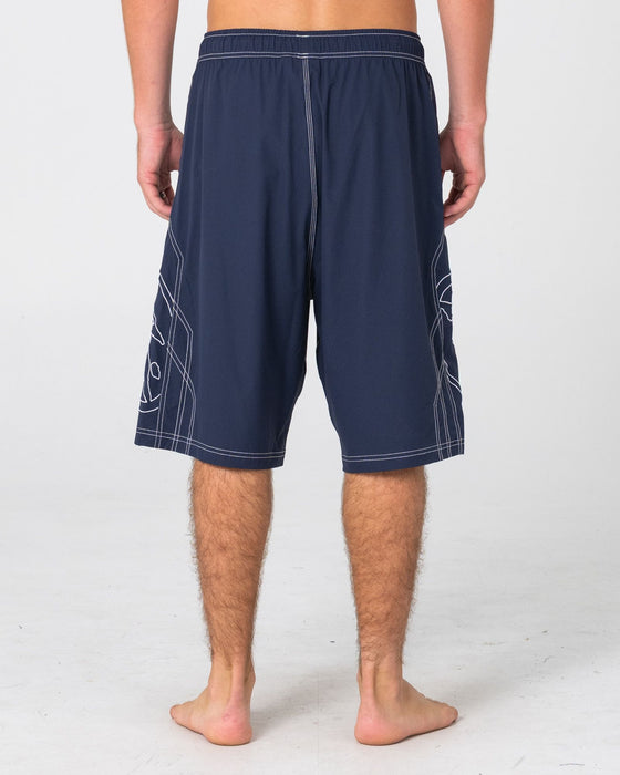 man-wearing-tombstones-hybrid-waist-boardshort-in-navy-blue