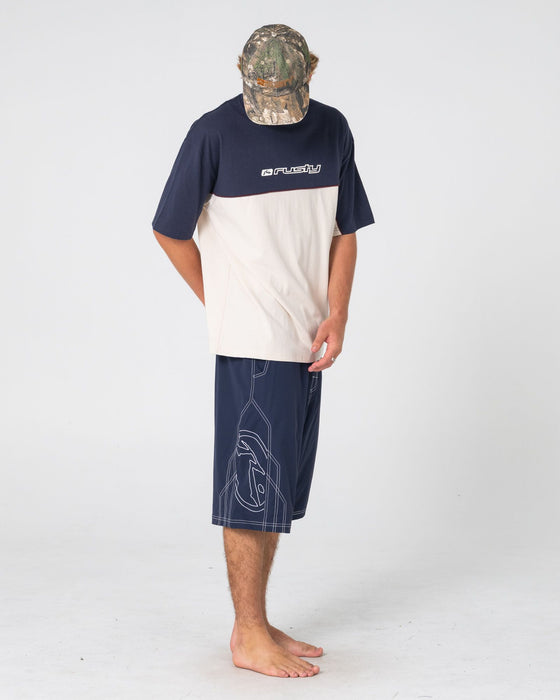 man-wearing-tombstones-hybrid-waist-boardshort-in-navy-blue