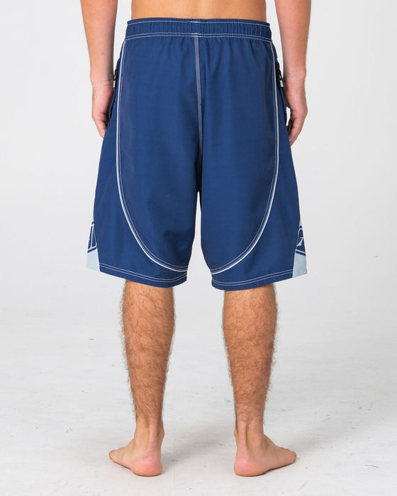 man-wearing-deathroll-hybrid-waist-boardshort-in-dark-blue