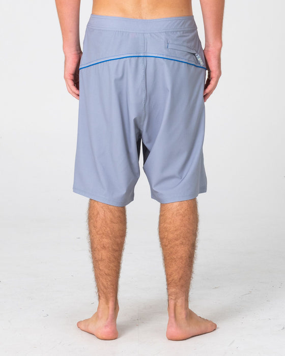 man-wearing-saber-tooth-fixed-waist-boardshort-in-stone-grey