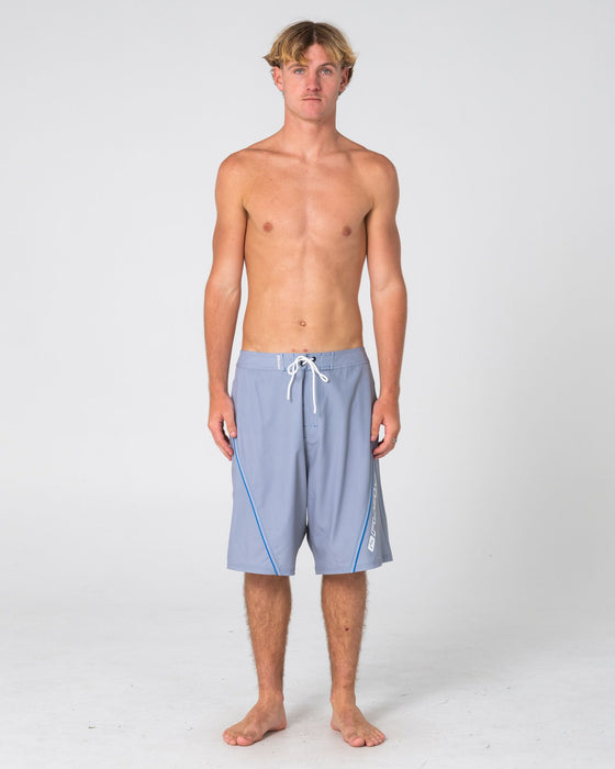man-wearing-saber-tooth-fixed-waist-boardshort-in-stone-grey
