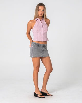 Woman wearing Flip Mommy Low Rise Mini Denim Skirt 2.0 in London Summer / Baby Pink