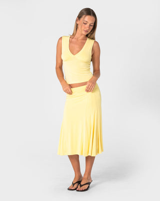 Woman wearing Vixen Low Rise Midi Skirt in Pale Banana