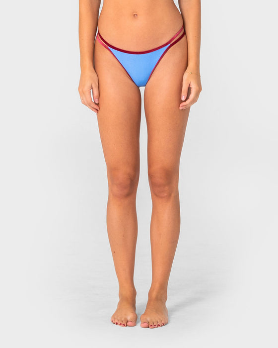 woman-wearing-sugary-brazilian-bikini-bottom-in-cornflour-blue-red