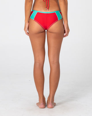 Woman wearing Voltron Booty Bikini Bottom in Tomato / Aqua