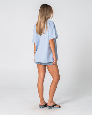 Woman wearing Wavers Tide Oversize Short Sleeve Tee in Retro Blue / White
