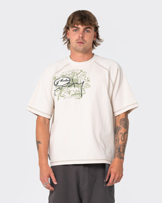 man-wearing-riddle-me-this-short-sleeve-tee-in-cream