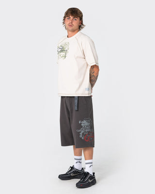 Man wearing Riddle Me This Short Sleeve Tee in Cream