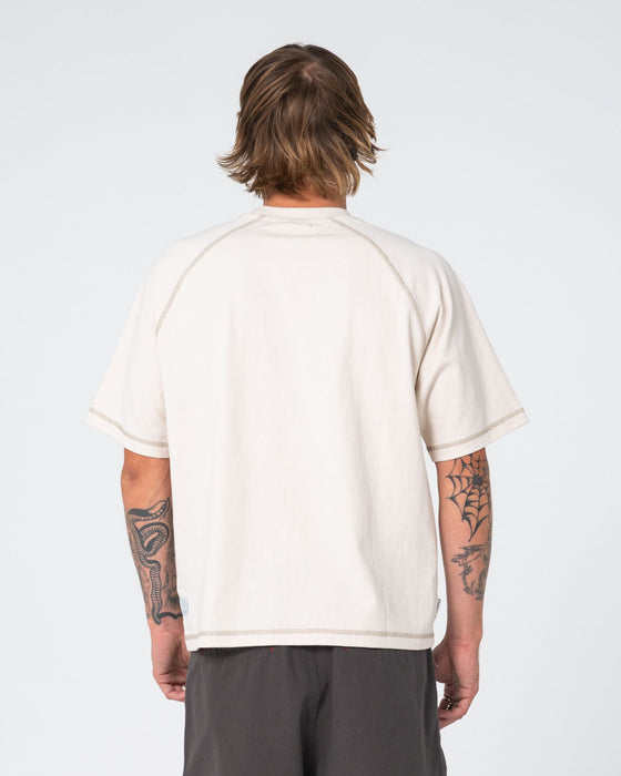 man-wearing-riddle-me-this-short-sleeve-tee-in-cream