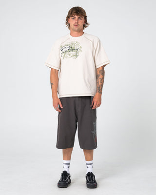 Man wearing Riddle Me This Short Sleeve Tee in Cream