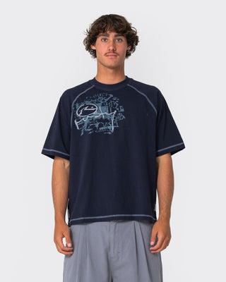 Man wearing Riddle Me This Short Sleeve Tee in Navy Blue