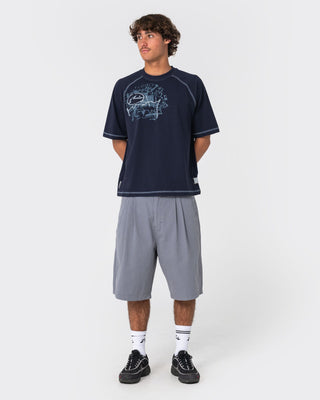 Man wearing Riddle Me This Short Sleeve Tee in Navy Blue