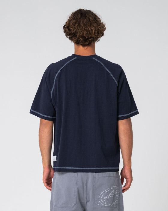 man-wearing-riddle-me-this-short-sleeve-tee-in-navy-blue
