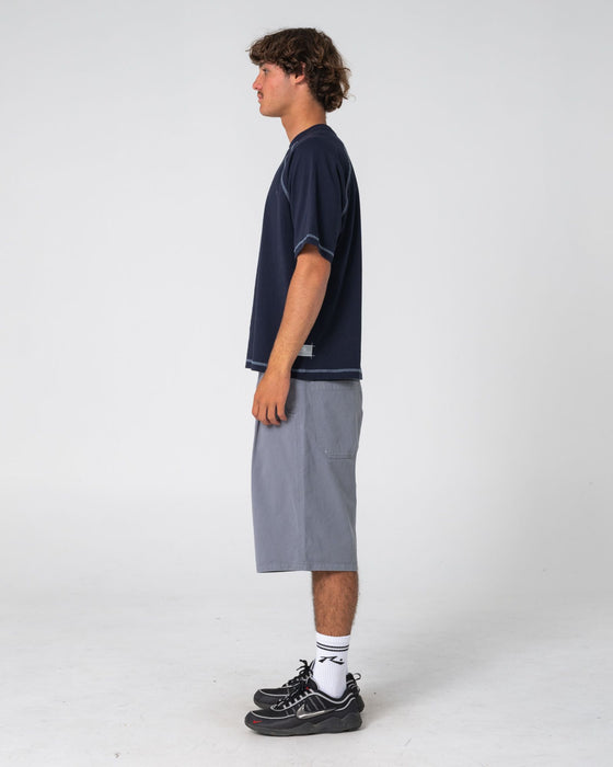 man-wearing-riddle-me-this-short-sleeve-tee-in-navy-blue