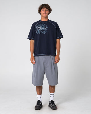 Man wearing Riddle Me This Short Sleeve Tee in Navy Blue