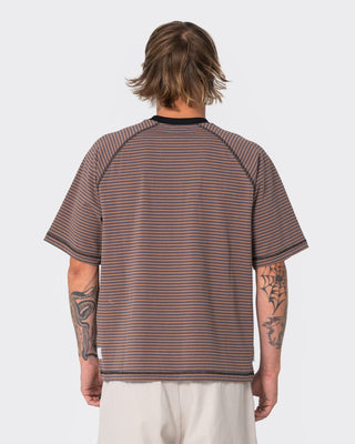 Man wearing Riddle Me This Short Sleeve Tee in Pinecone