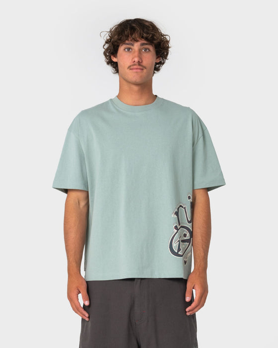 man-wearing-art-attack-short-sleeve-tee-in-seafoam