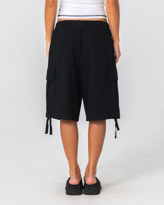 Woman wearing River Low Rise Baggy Cargo Short in Washed Black