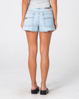 Woman wearing Penny Kick Flare Denim Short 2.0 in Sky Blue Heather