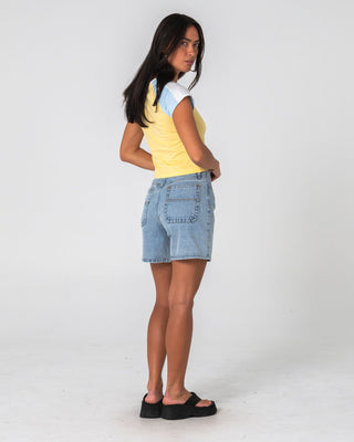Woman wearing Cyprus High Denim Short 2.0 in True Blue