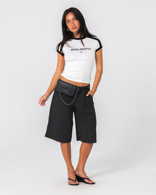 Woman wearing Big Bad Finance Mommy Low Rise Short in Black Pinstripe