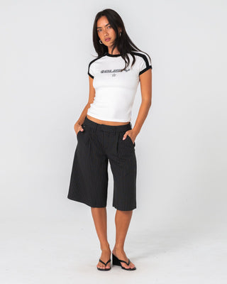 Woman wearing Big Bad Finance Mommy Low Rise Short in Black Pinstripe