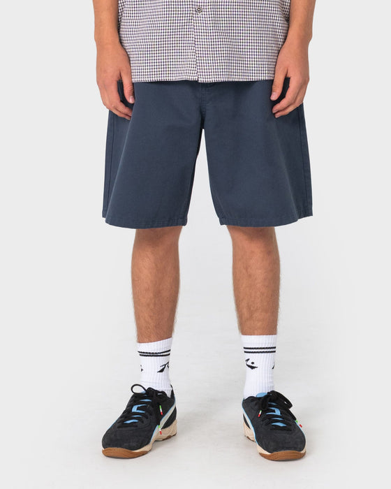 man-wearing-rumble-chino-short-in-navy-blue