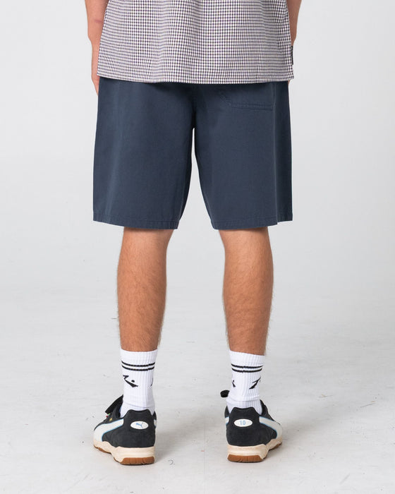 man-wearing-rumble-chino-short-in-navy-blue