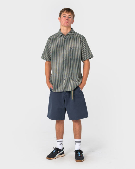 man-wearing-datsun-check-short-sleeve-shirt-in-dark-green