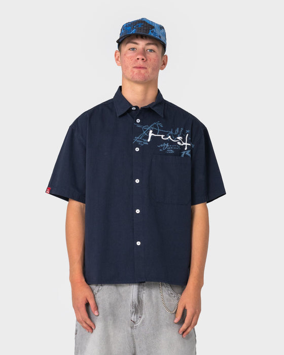 man-wearing-shockwave-short-sleeve-shirt-in-navy-blue