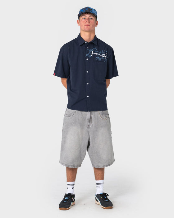 man-wearing-shockwave-short-sleeve-shirt-in-navy-blue