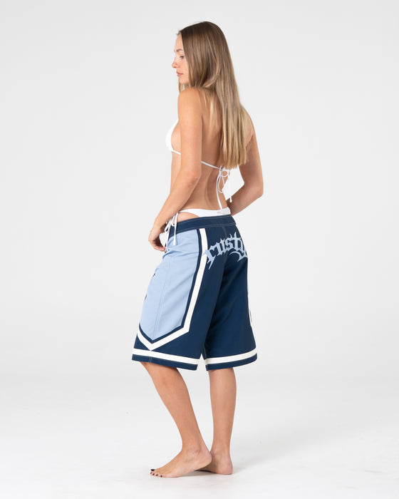 woman-wearing-farrah-long-boardshorts-in-navy-blue