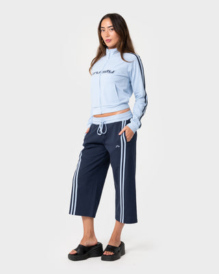 Woman wearing Maneater Fitted Zip Through Track Jacket in Retro Blue / Navy