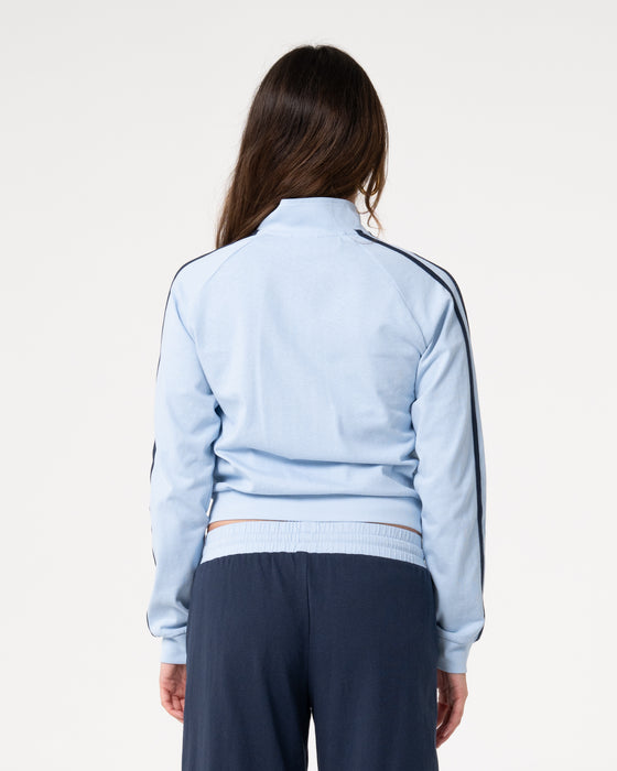 woman-wearing-maneater-fitted-zip-through-track-jacket-in-retro-blue-navy