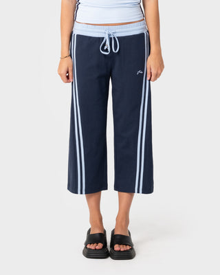 Woman wearing Maneater Low Rise Capri Track Pant in Retro Blue