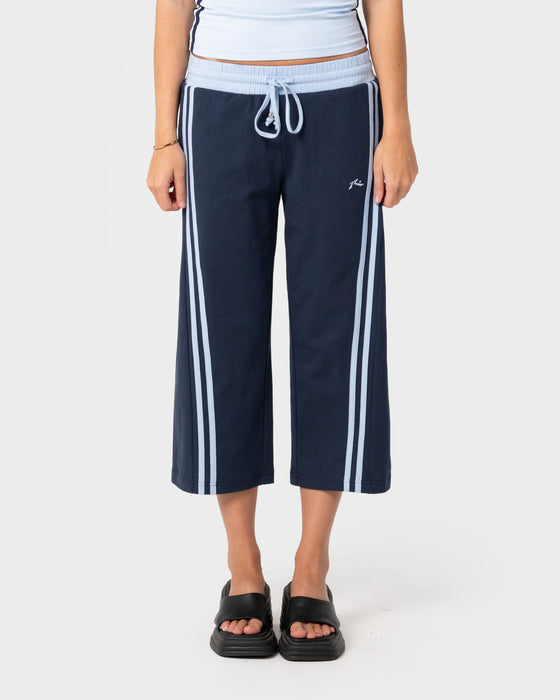woman-wearing-maneater-low-rise-capri-track-pant-in-navy-blue-retro-blue