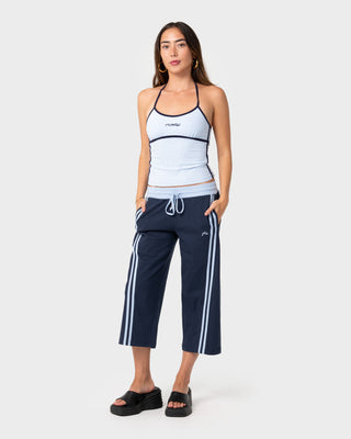 Woman wearing Maneater Low Rise Capri Track Pant in Navy Blue / Retro Blue