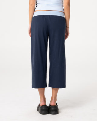 Woman wearing Maneater Low Rise Capri Track Pant in Retro Blue