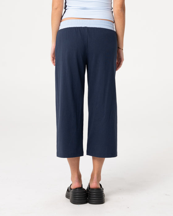 woman-wearing-maneater-low-rise-capri-track-pant-in-navy-blue-retro-blue