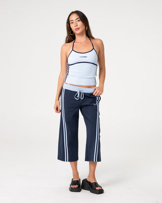 Woman wearing Maneater Low Rise Capri Track Pant in Retro Blue