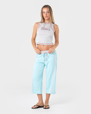Woman wearing Maneater Low Rise Capri Track Pant in Powder Aqua