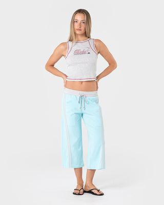 Woman wearing Maneater Low Rise Capri Track Pant in Powder Aqua