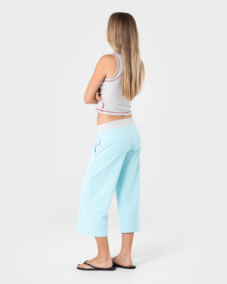 Woman wearing Maneater Low Rise Capri Track Pant in Powder Aqua