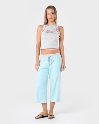 Woman wearing Maneater Low Rise Capri Track Pant in Powder Aqua