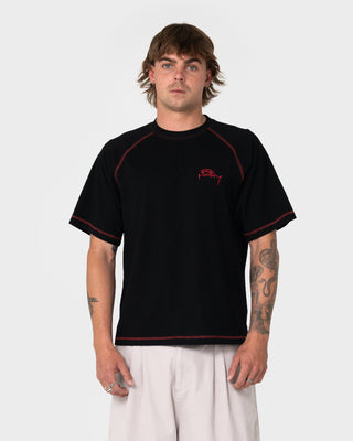 Man wearing Clarty B Raglan Tee in Black