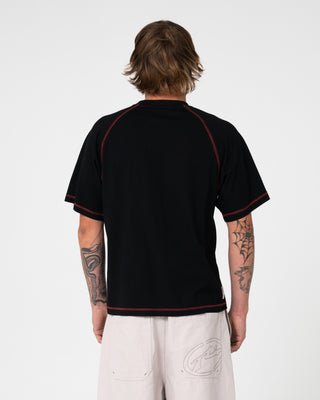Man wearing Clarty B Raglan Tee in Black
